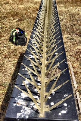 Runway sign with plastic spikes installed